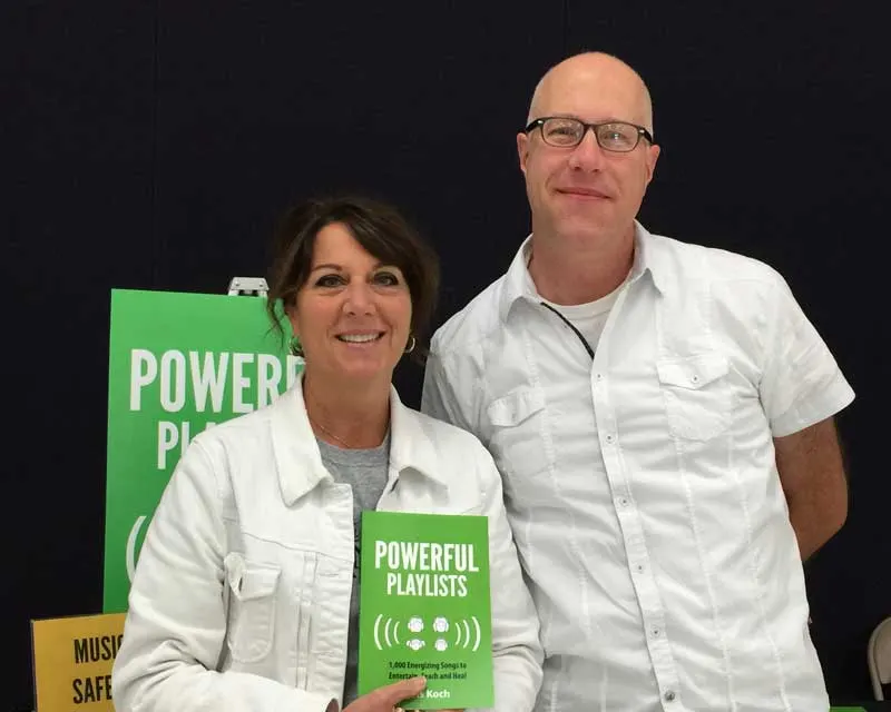 Kris Koch with a reader holding a copy of Powerful Playlists